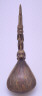 Unknown / Spoon handle: long figure with staff and headdres, standing on    back on animal / circa 1900