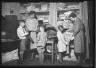 Lewis W. Hine / Woman Dressing Children / ca. 1906-1938