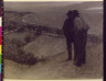 W. T Smedley / Men on hill overlooking village / 1897