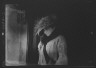 Arnold Genthe / Slater, Mrs., standing by the door of a house in Long Beach / 1924 July