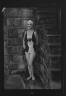 Arnold Genthe / Ford, Elsie, Miss, standing outdoors in a bathing suit / 1932 July