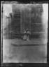 Arnold Genthe / Woman sitting on steps holding a basket, New Orleans / between 1920 and 1926