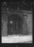 Arnold Genthe / Arched wrought iron gate in free-standing brick wall, New Orleans or Charleston, South Carolina / between 1920 and 1926