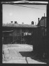 Arnold Genthe / View of two-story dwellings with laundry hanging over balcony railing, New Orleans / between 1920 and 1926