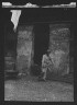 Arnold Genthe / Man cleaning out a small building, New Orleans or Charleston, South Carolina / between 1920 and 1926