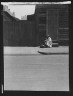 Arnold Genthe / Woman sitting on steps holding a basket, New Orleans / between 1920 and 1926