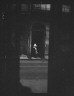 Arnold Genthe / View from across street of a woman cleaning the sidewalk, New Orleans / between 1920 and 1926