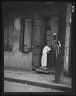 Arnold Genthe / Woman standing in a doorway in the French Quarter, New Orleans / between 1920 and 1926