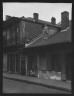 Arnold Genthe / View from across street of two children standing in a doorway in the French Quarter, New Orleans / between 1920 and 1926