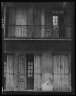 Arnold Genthe / Facade of a building with shuttered doors and balcony, New Orleans or Charleston, South Carolina / between 1920 and 1926