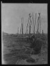 Arnold Genthe / Ainu seated outside working on nets / 1908