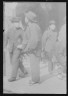 Arnold Genthe / Men standing or walking on a street, Chinatown, San Francisco / between 1896 and 1906