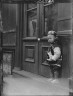 Arnold Genthe / Small boy standing in front of a door, Chinatown, San Francisco / between 1896 and 1906