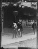 Arnold Genthe / Man carrying a child accompanied by another child, Chinatown, San Francisco / between 1896 and 1906