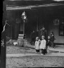 Arnold Genthe / Man and two children crossing a street, Chinatown, San Francisco / between 1896 and 1906