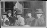 Arnold Genthe / Group of men standing on a street, Chinatown, San Francisco / between 1896 and 1906