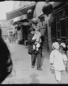 Arnold Genthe / A holiday visit, Chinatown, San Francisco / between 1896 and 1906