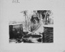 Arnold Genthe / Ainu man seated outdoors on a mat covered with clay containers / between 1908 and 1942; from a negative taken in 1908