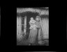 Arnold Genthe / Ainu woman holding a child standing outside a hut / between 1908 and 1942; from a negative taken in 1908