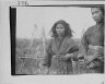 Arnold Genthe / Two Ainu women standing outside in front of a pole fence / between 1908 and 1942; from a negative taken in 1908