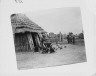 Arnold Genthe / Ainu women and children outside a hut / between 1908 and 1942; from a negative taken in 1908