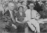 Arnold Genthe / Timken, W.R., Mr., and Mrs., with John Hemming Fry, seated outdoors / 1938 July