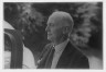 Arnold Genthe / Timken, W.R., Mr., standing next to his car / 1938 July