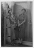 Arnold Genthe / Benson, Mary, Mrs., and Alice DeLamar, standing by the door of a house / 1933