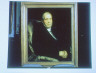 Unknown / Photograph of a painting of a man wearing a black suit and a white shirt seated in a chair / between 1906 and 1942