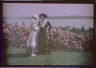 Arnold Genthe / Viola Kraus and Helen Freeman standing together in front of flowering bush / 1915