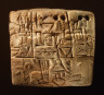 Mesopotamian / Administrative tablet with cylinder seal impression of a male figure, hunting dogs, and boars / 3100-2900 B.C.