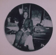 Chinatown Album: Man Sitting on a Bed