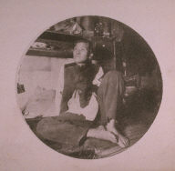 Chinatown Album: Man Sitting with Bent Knees