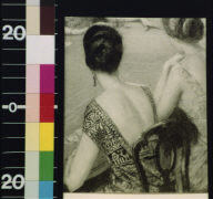 Backs of two women in evening dress at gambling table