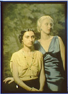 Two women, one dressed in yellow and one in blue